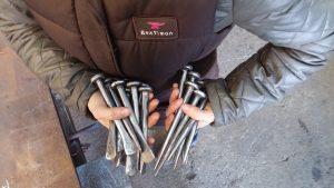 Bex Simon Artist Blacksmith holding baby tools
